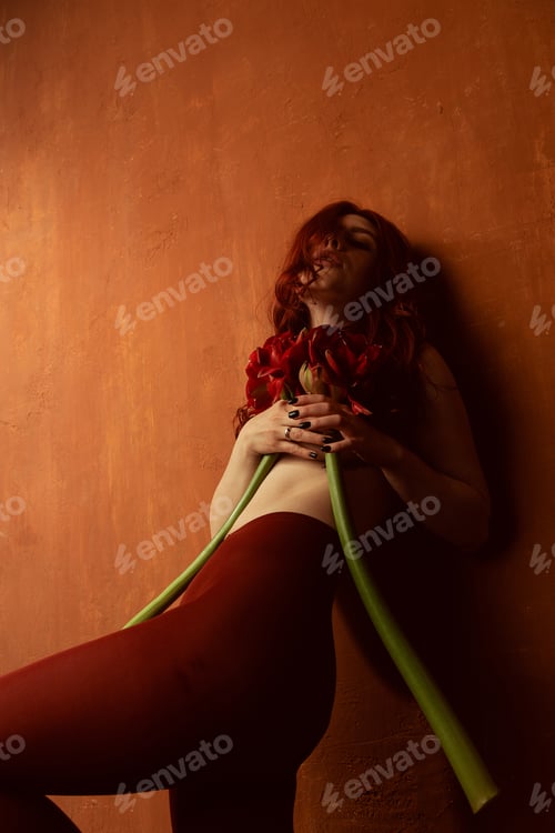Preview: Beautiful Girl With Red Hair, Makeup And Styling. Red Flowers In The Hands
