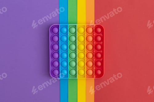 Preview: Colorful anti-stress pop it sensory toys for children on multicolored background.