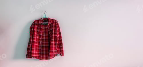 Preview: Red Plaid Shirt Hanging on a Light Wall