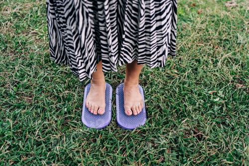 Preview: Close-up woman is standing barefoot on the boards sadhu on nails doing the meditative practice