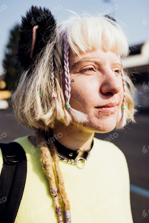 Preview: Gender fluid no make up young woman outdoor looking over