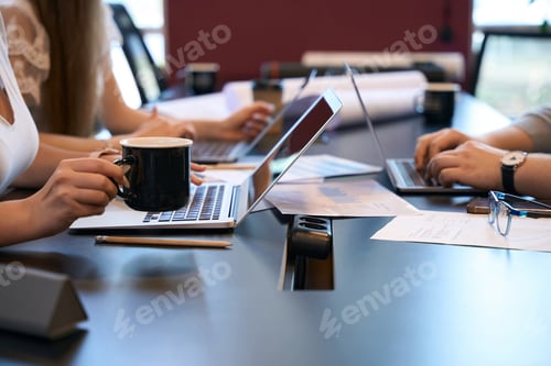 Preview: Architectural team typing on laptops in workplace