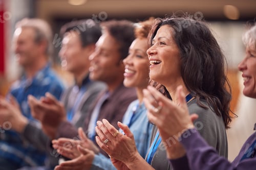 Preview: Group Of Casually Dressed Businessmen And Businesswomen Applauding Presentation At Conference