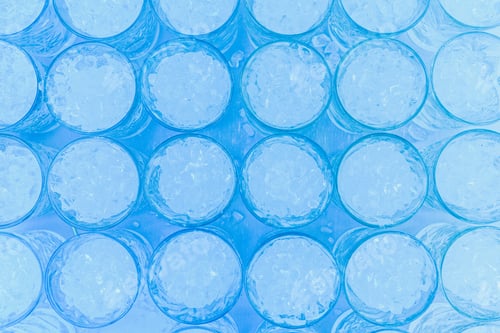 Preview: Pattern of glasses with ice ready to prepare a cocktail with refreshing background.