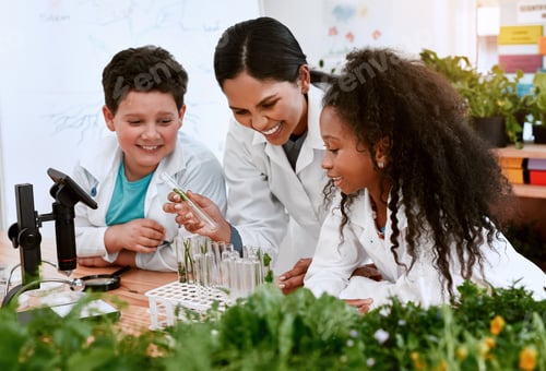 Visualização: Shot of an adorable little boy and girl learning about plants with their teacher at school