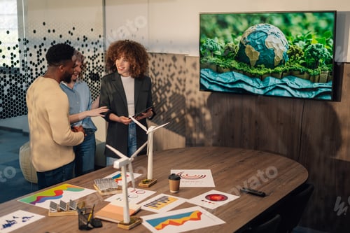 Preview: Interracial environmentalists discussing renewable energy technology.