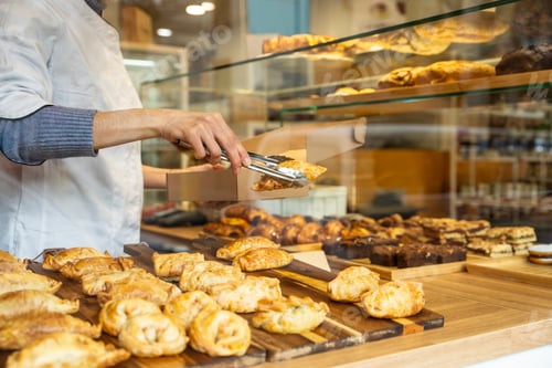 Preview: Baker preparing fresh empanadas in a small bakery