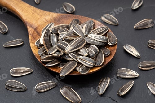 Preview: Sunflower Seeds in a Wooden Spoon on Stone