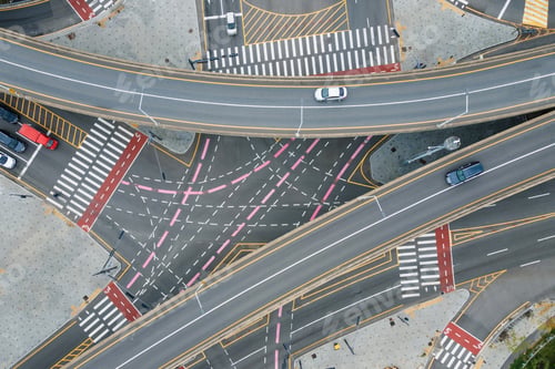 Preview: Cars drive along traffic intersection in the city, top view.