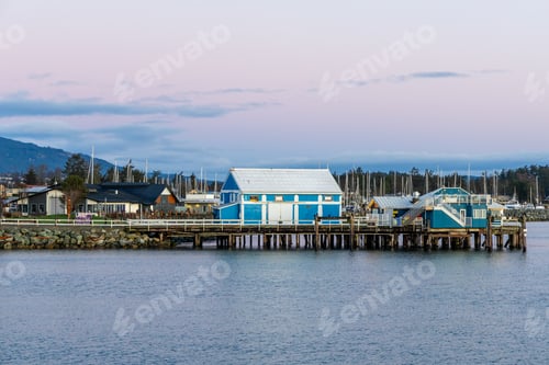 Preview: Scenic Waterfront Setting with Colorful Dock and Buildings in Evening Light