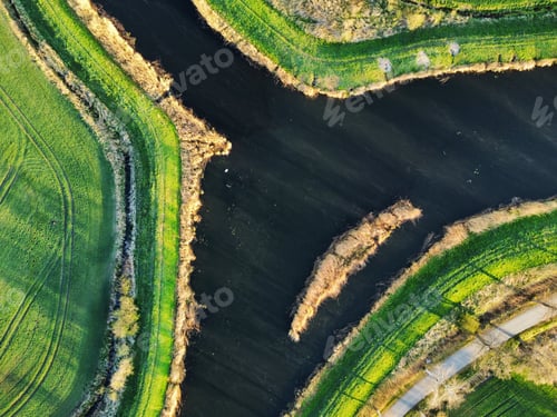 Preview: Aerial view of a river in field in spring