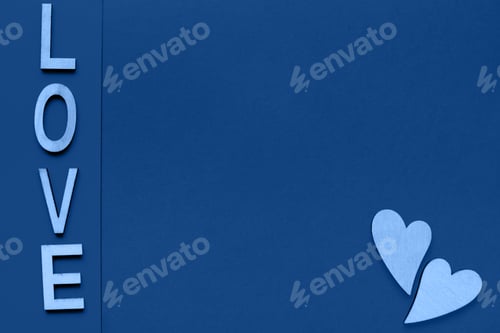 Preview: The word love consists of wooden letters located on a blue background with space for text