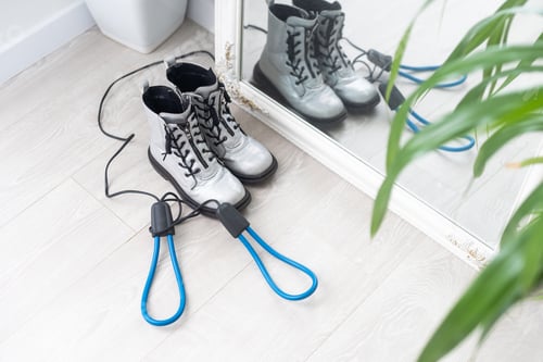 Preview: Shoes and electric dryer on white wooden background,