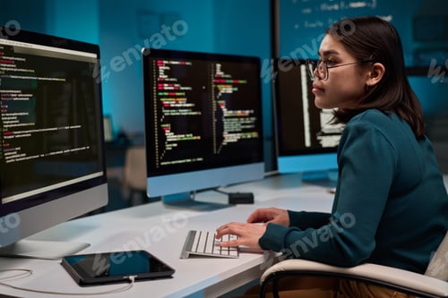 Preview: Female Computer Programmer Typing at Keyboard