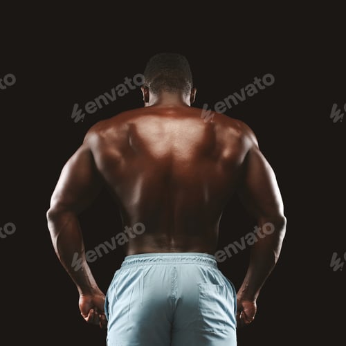 Preview: Unrecognizable afro sportsman showing athletic back on black background