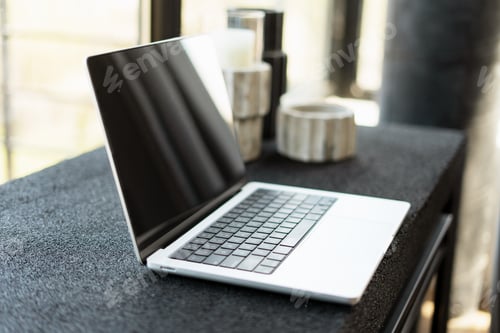 Preview: Modern laptop showing blank screen sitting on desk in home office