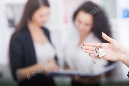 Preview: Real estate agent giving house keys to a customer