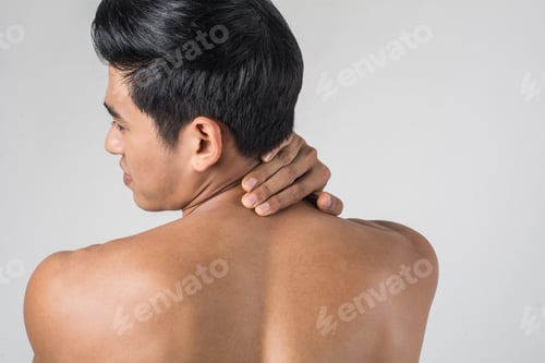 Preview: Muscular man use handles at the neck to relieve pain isolated on white background.
