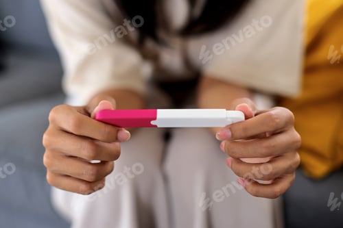 Preview: Positive Pregnancy Test Held Indoors by Adult