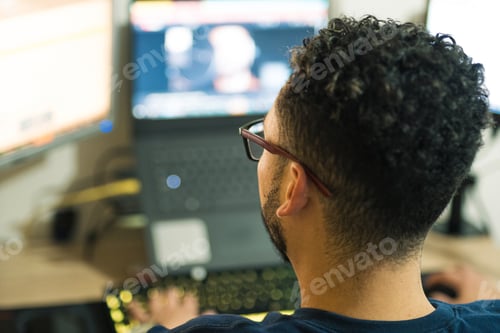 Preview: Programmer working remotely from home and developing web pages at night. Online jobs to generate ext