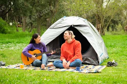 Preview: A couple playing the guitar and singing while camping in nature