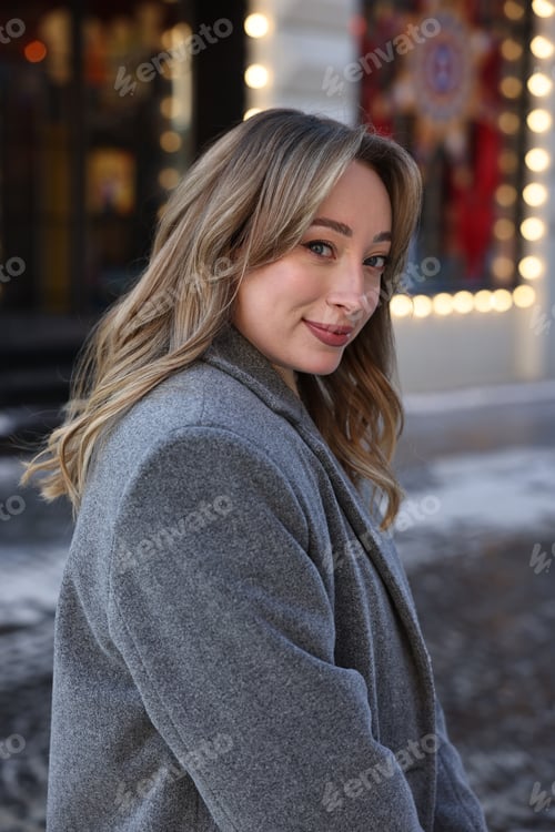 Preview: Portrait of charming woman on city street in winter