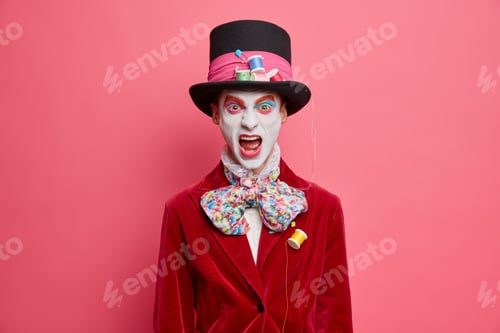 Preview: Emotional street performer dressed as hatter from fairytale dressed in big hat and red jacket has ar