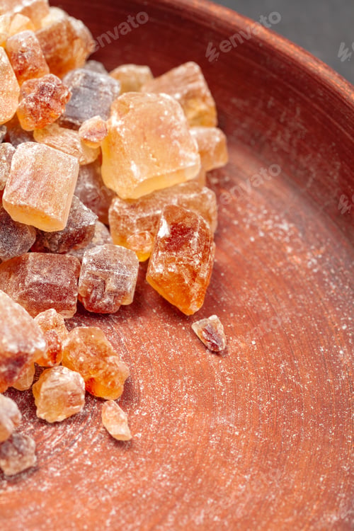 Preview: brown sugar rock organic crystalline close up on dark background