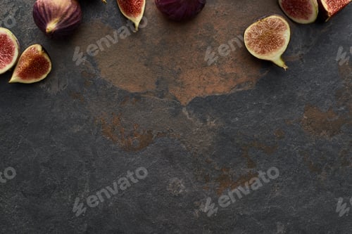 Preview: Top View of Ripe Whole And Cut Delicious Figs on Stone Background