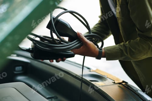 Preview: Driver Putting Charging Cable in Trunk