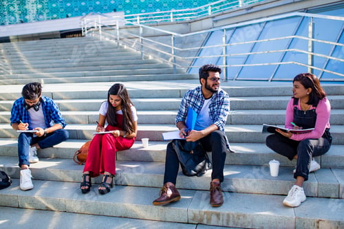 Preview: indian students keeping distance and do home work outdoors