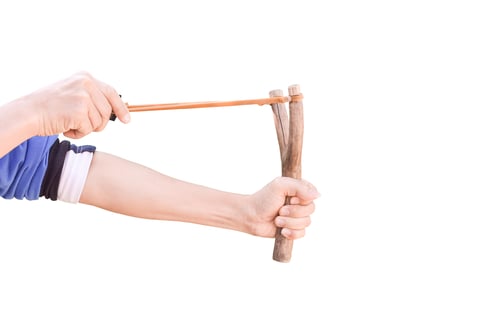 Preview: Hand holding aiming Slingshot, Isolated on white background with clipping path.