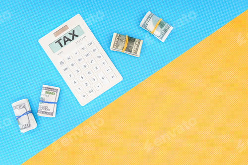 Preview: top view of calculator with word 'tax' and money rolls on blue and yellow background