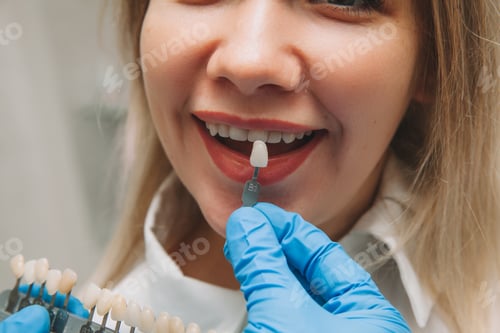 Preview: the girl in the dentist's office selects the color of the tooth enamel
