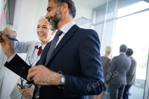 Preview: Diverse group of focused work colleagues during a planning and strategy meeting in office