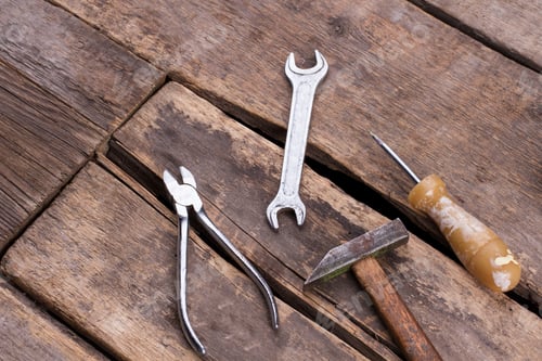 Preview: Used construction tools on old wooden boards.