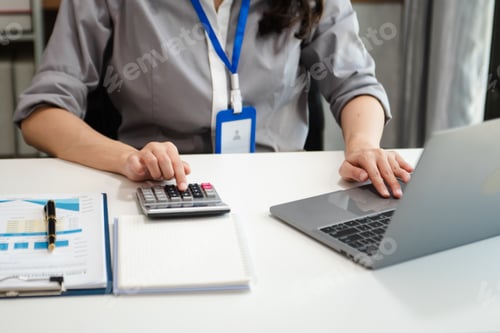 Preview: Businessman hands working with finances about cost and calculator and laptop with tablet, smartphone