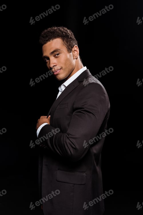 Preview: happy mixed race man looking at camera isolated on black