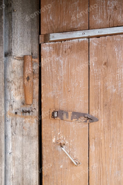Preview: Wooden latch and metal padlock loop on painted plank front door, outdoors. Country style