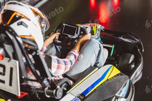 Preview: Close-Up of Racer Steering a Go-Kart on Indoor Track