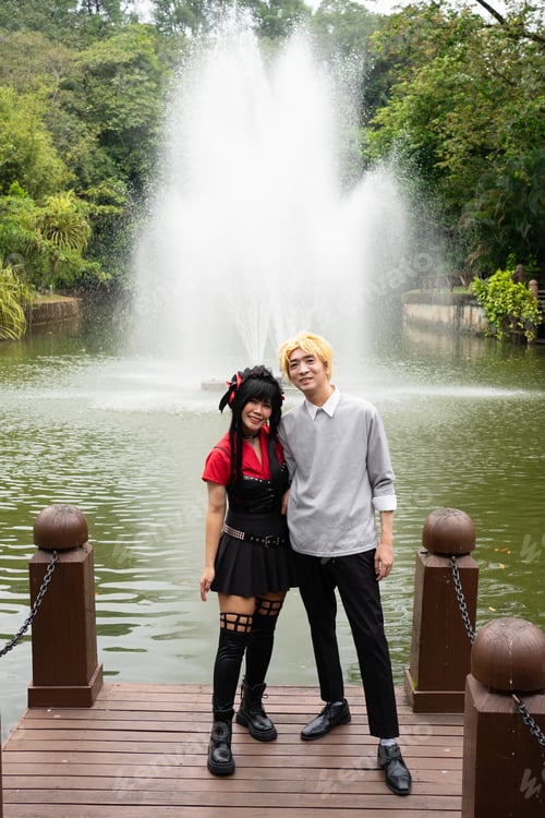 Preview: Cosplayers posing on pier by fountain in park