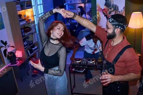 Preview: Young Woman and young Man Dancing Together at House Party