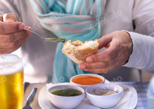 Preview: At the restaurant a woman tastes one of the typical sauces of the Canary Islands, called "mojo"