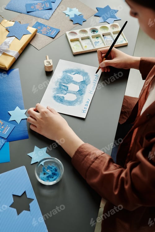 Preview: Young unrecognizable woman creating new Hanukkah postcard