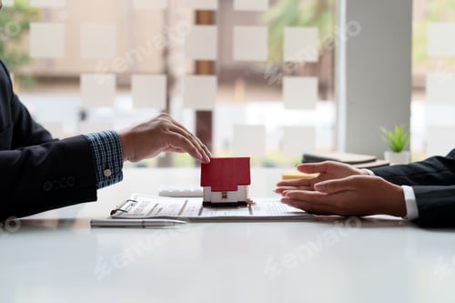 Preview: Real estate agent sales manager giving house model to customer after signing rental lease contract