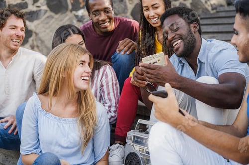 Preview: Young diverse people having fun listening music with boombox stereo outdoor in the city