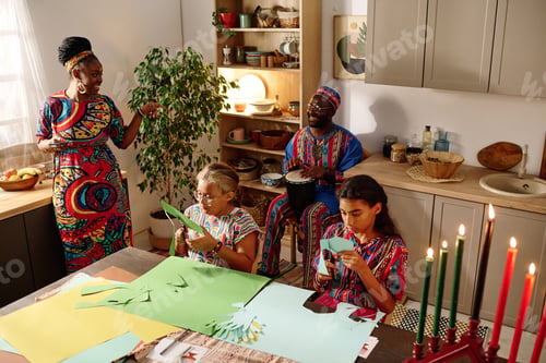 Preview: Two girls cutting paper and preparing greeting cards for kwanzaa holiday