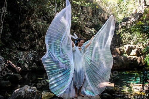 Preview: Woman in light outfit dancing near river in nature