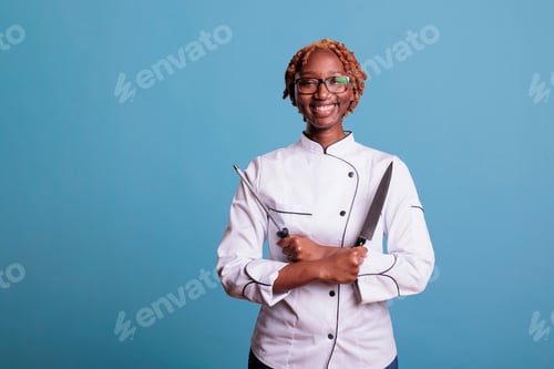 Preview: Professional female cook with cooking utensils