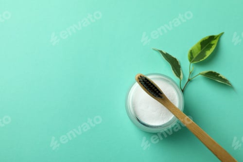 Preview: Eco friendly toothbrush and tooth powder on mint background